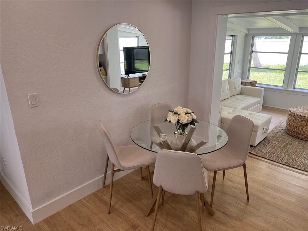1220 Embassy Lane Naples, FL 34104 - Photo 3 of 11 a view of a dining room with furniture and wooden floor