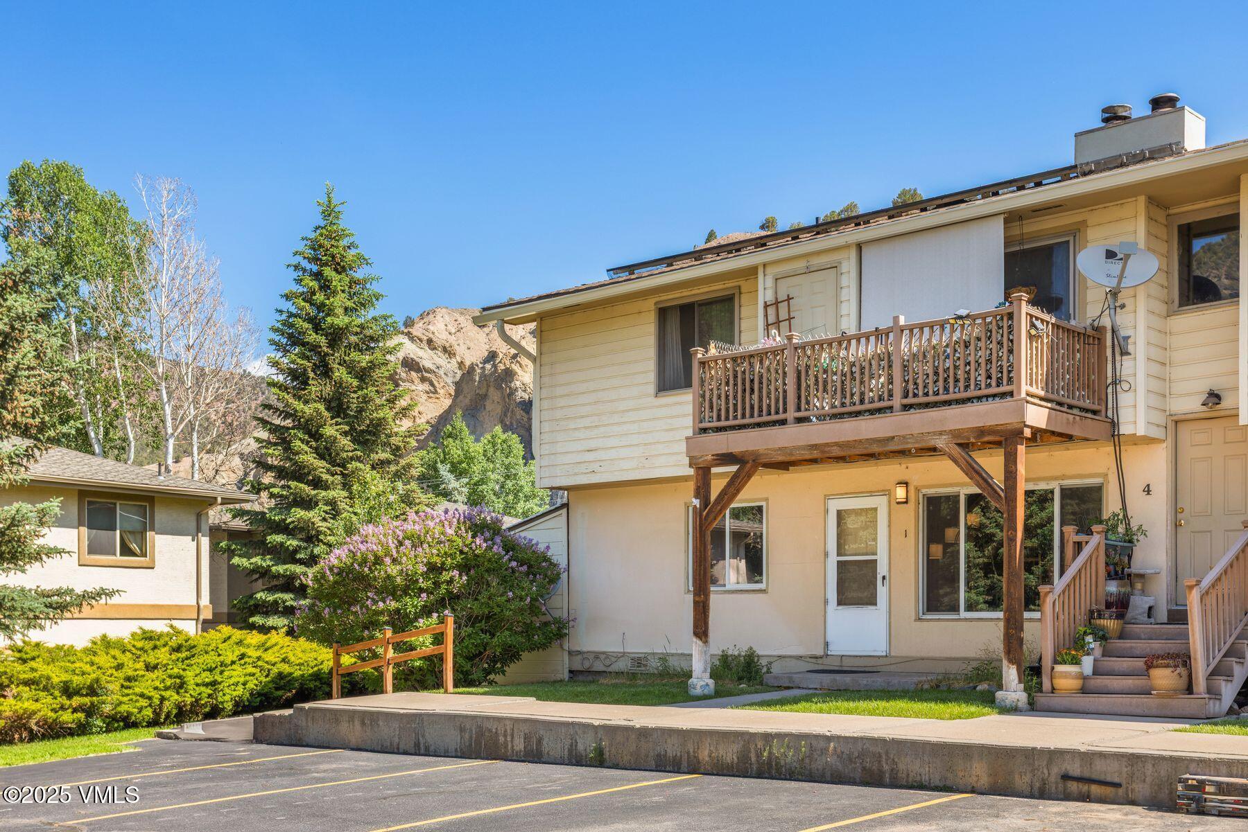 600 Price Lane, Unit 1 Gypsum, CO 81637 - Photo 1 of 26 a front view of a house with trees and plants