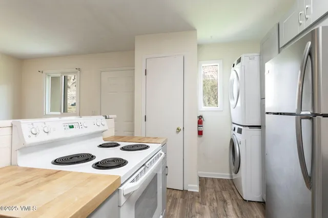 a kitchen with a sink a refrigerator and a stove