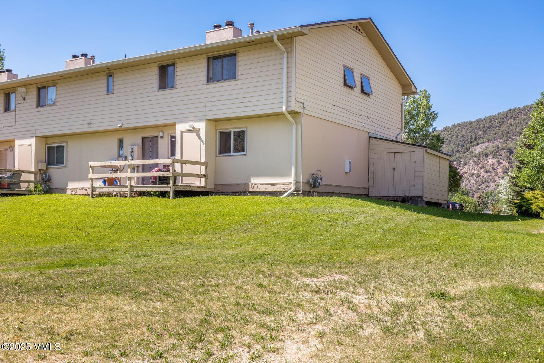 600 Price Lane, Unit 1 Gypsum, CO 81637 - Photo 21 of 26 a view of a house with a yard and sitting area