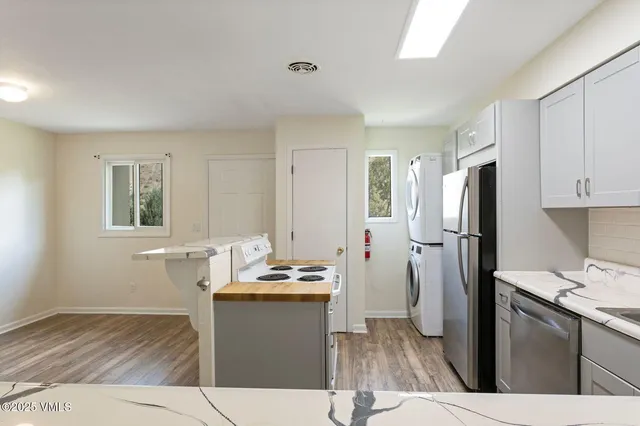 a kitchen with kitchen island a sink stove and refrigerator