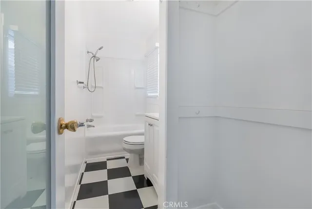 a bathroom with a toilet a sink and a shower