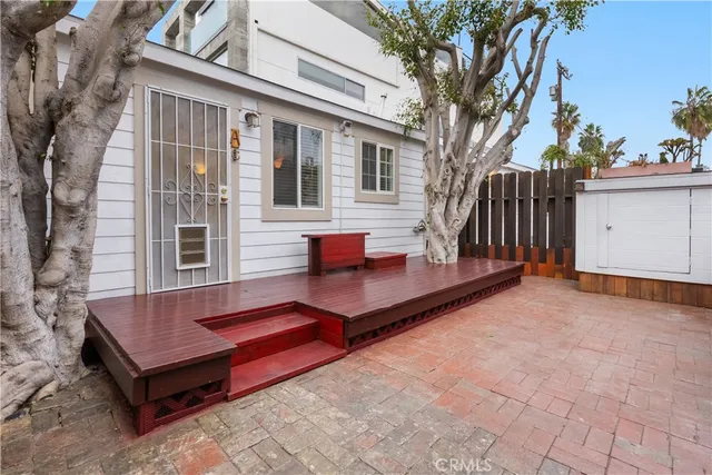 a view of a wooden bench in backyard of house
