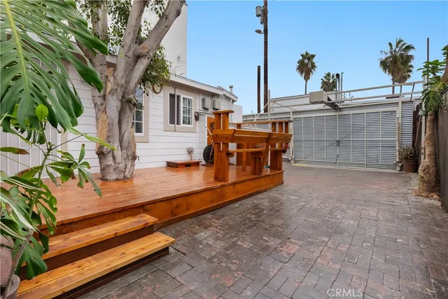 a view of backyard with a deck and a fire pit
