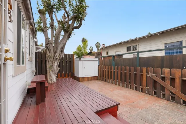 a view of backyard with a deck and wooden floor