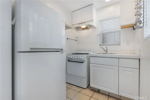 a kitchen with cabinets and appliances