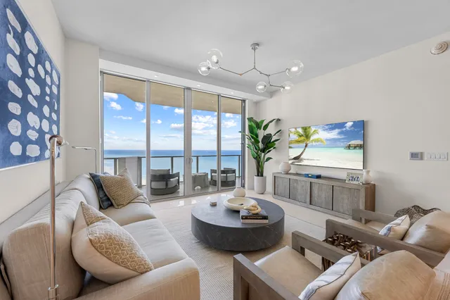 a living room with furniture and a large window