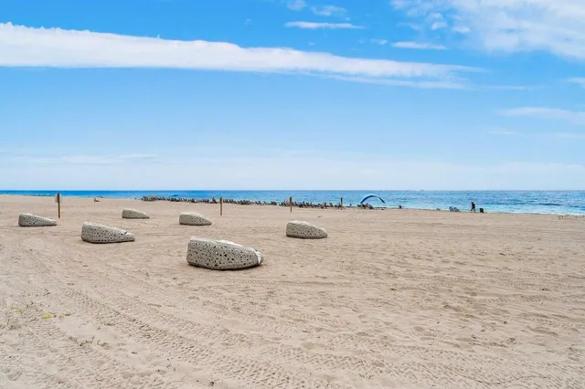 a view of a workspace with furniture and floor to ceiling window