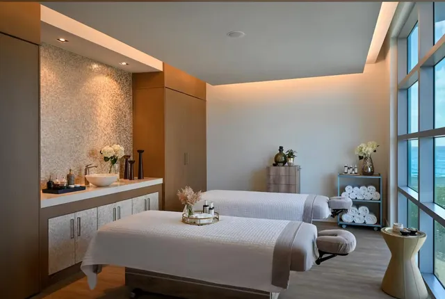 a living room filled with lots of furniture and a chandelier