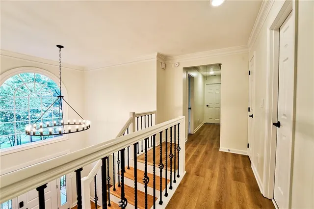 an empty room with ceiling fan and windows