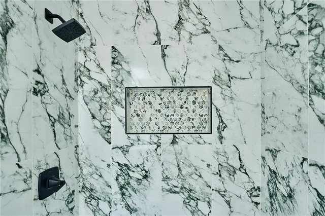 an empty room with windows and ceiling fan