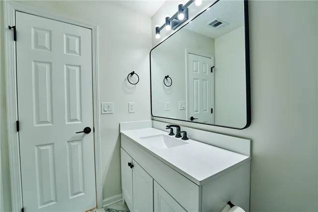 an empty room with a fan & a window