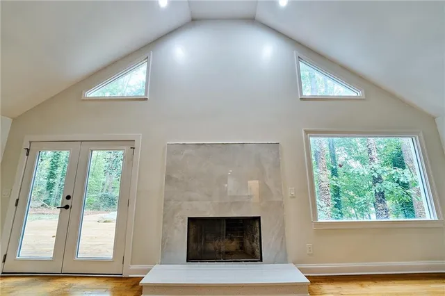 a living room with a fireplace and a large window