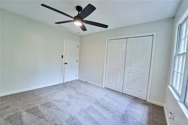 a view of staircase with lots of frames on wall and wooden floor