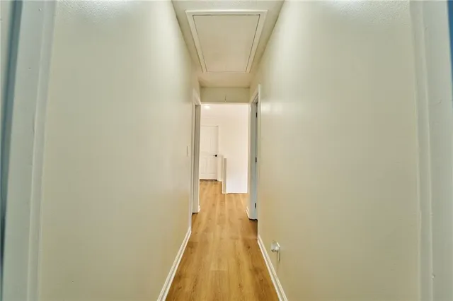 a kitchen with granite countertop cabinets stainless steel appliances and wooden floor