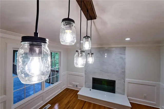 a view of empty room with wooden floor and fireplace