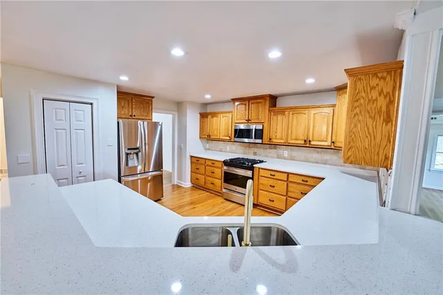 a view of a room with wooden floor and white walls