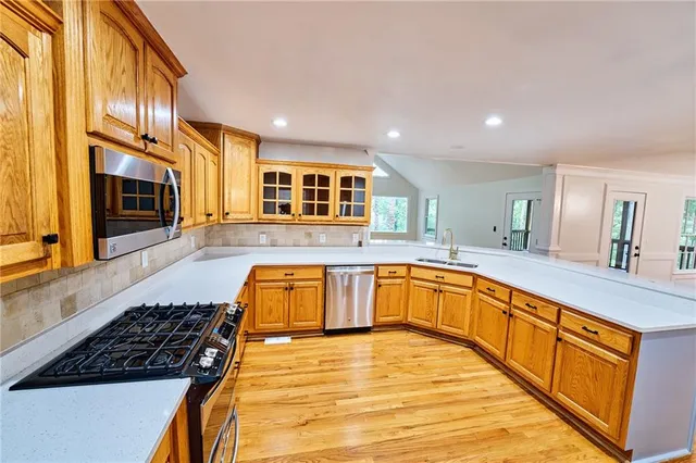 a view of a room with wooden floor ceiling fan and window