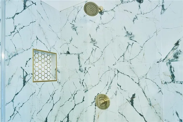 an empty room with windows and ceiling fan