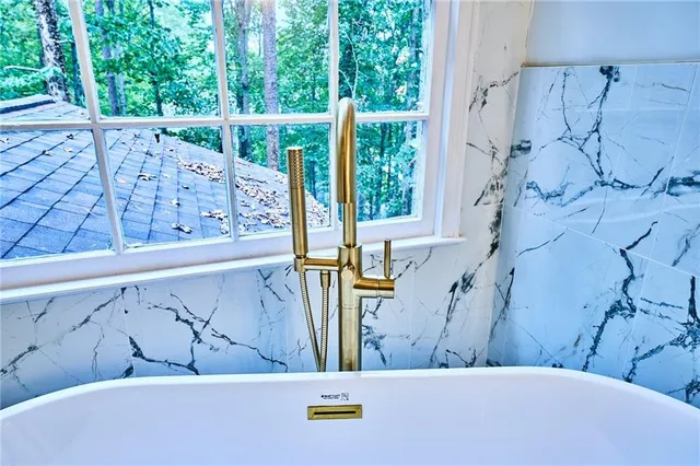 an empty room with a ceiling fan and a window