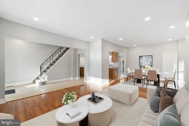 a living room with furniture and wooden floor