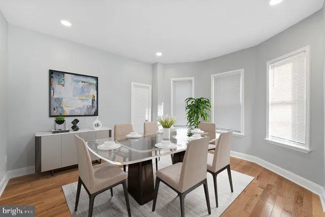 a view of a dining room with furniture window and wooden floor
