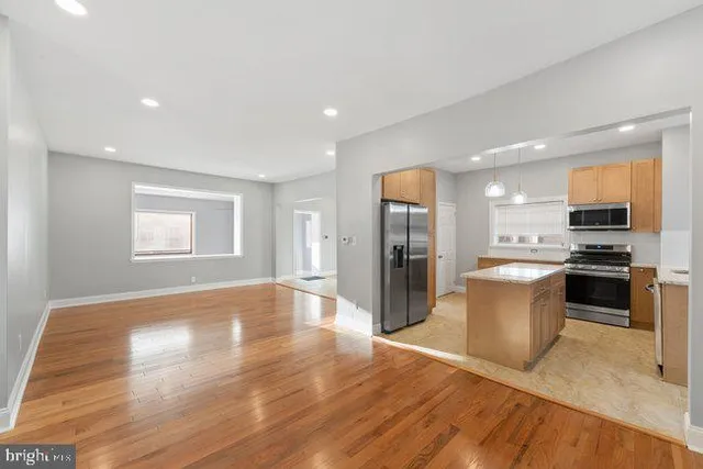 a kitchen with a refrigerator and a stove top oven