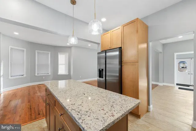 a kitchen with stainless steel appliances granite countertop counter space a refrigerator and a sink
