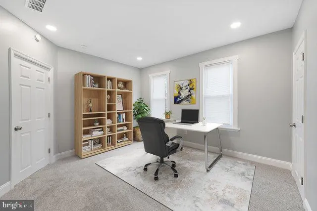 a bathroom with a granite countertop toilet sink and mirror