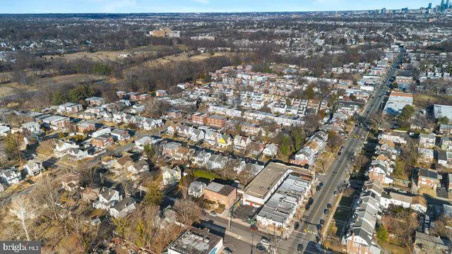 a view of a big house with a big yard and large tree