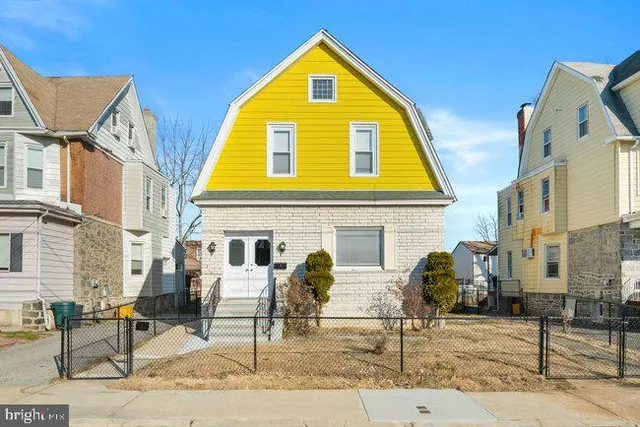 a front view of a house with white walls