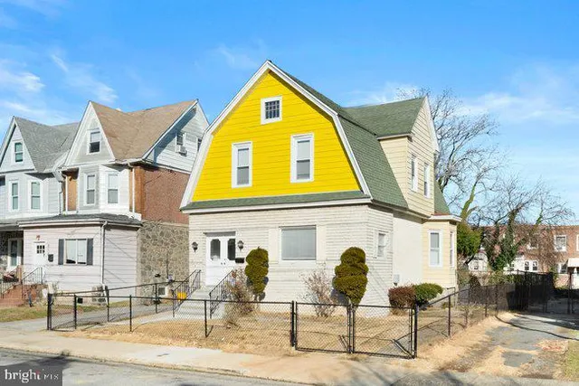 a front view of a residential apartment building with a yard
