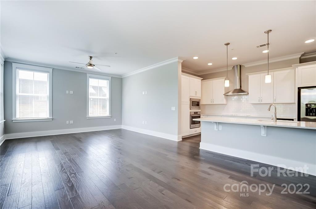 830 Providence Road, Unit 102 Charlotte, NC 28207 - Photo 16 of 31 a view of a kitchen with wooden floor and a window