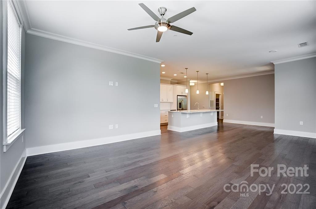 830 Providence Road, Unit 102 Charlotte, NC 28207 - Photo 18 of 31 an empty room with wooden floor and windows