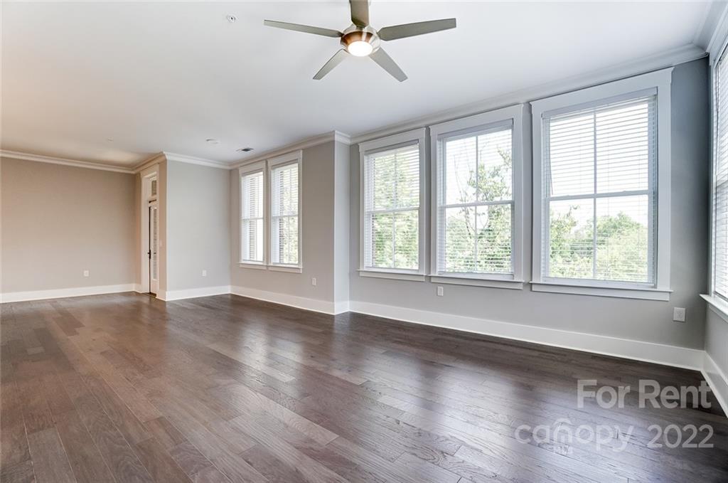 830 Providence Road, Unit 102 Charlotte, NC 28207 - Photo 20 of 31 a view of an empty room with wooden floor and a window