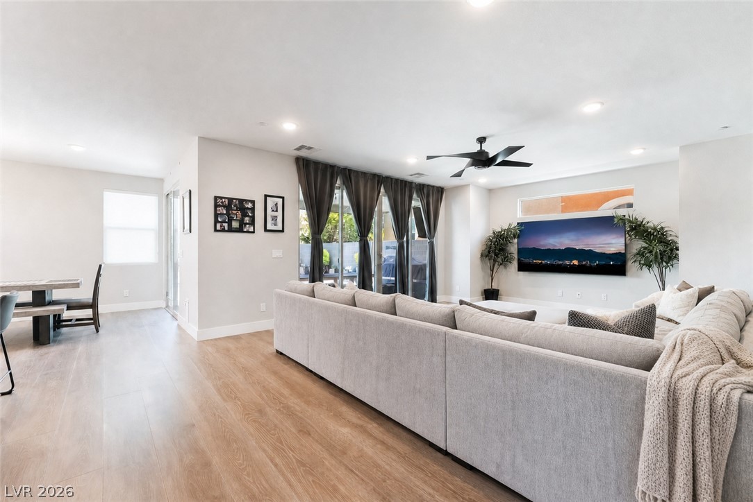 2166 Trivero Street Henderson, NV 89044 - Photo 7 of 61 A contemporary great room blends living and dining with warm wood flooring and bright recessed lighting.
