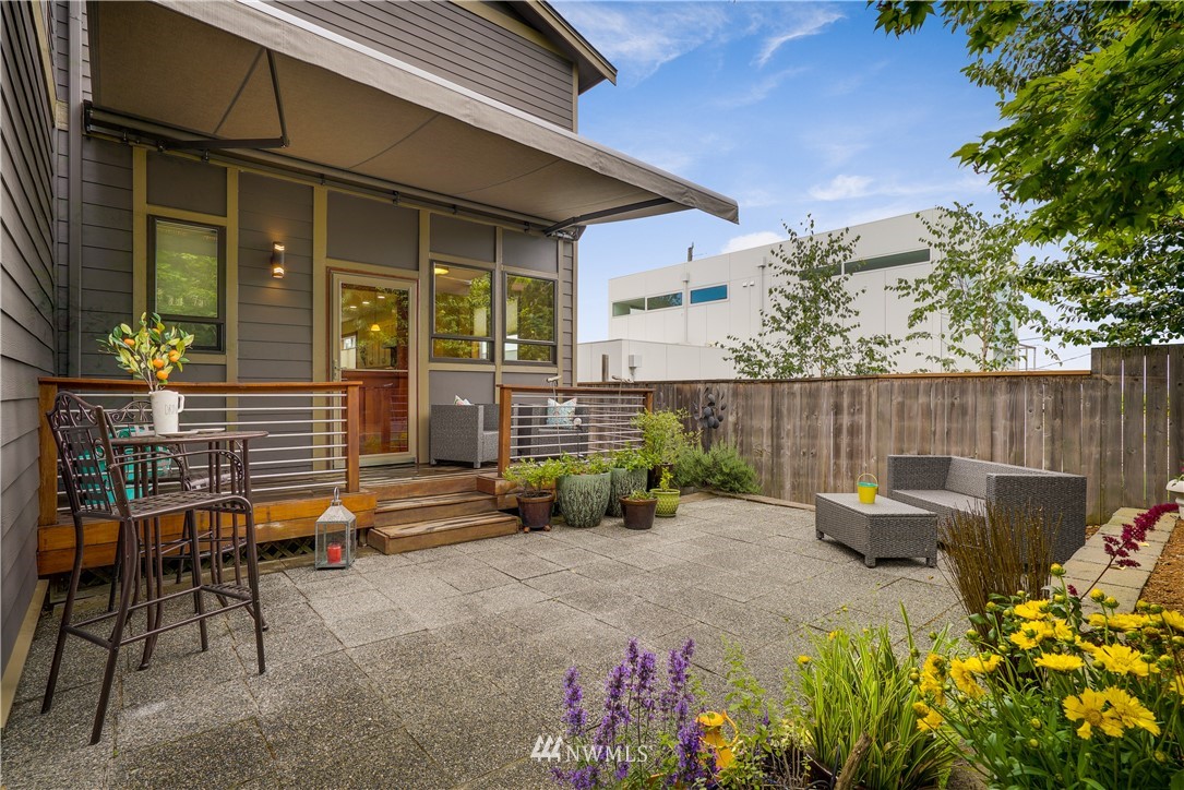 1023 West Ruffner Street Seattle, WA 98119 - Photo 11 of 25 a backyard of a house with outdoor seating