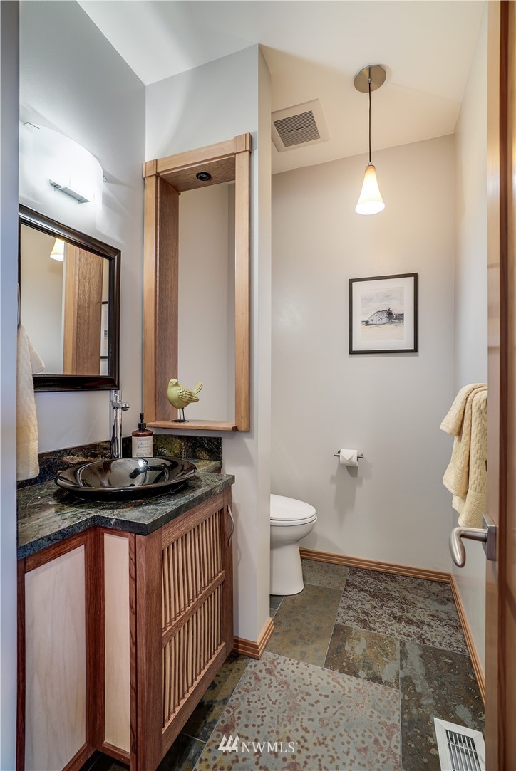 1023 West Ruffner Street Seattle, WA 98119 - Photo 13 of 25 a bathroom with a sink a toilet and mirror