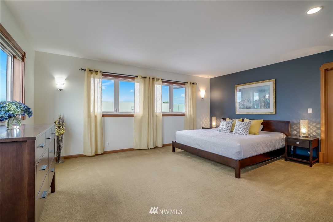 1023 West Ruffner Street Seattle, WA 98119 - Photo 16 of 25 a spacious bedroom with a large bed and potted plant