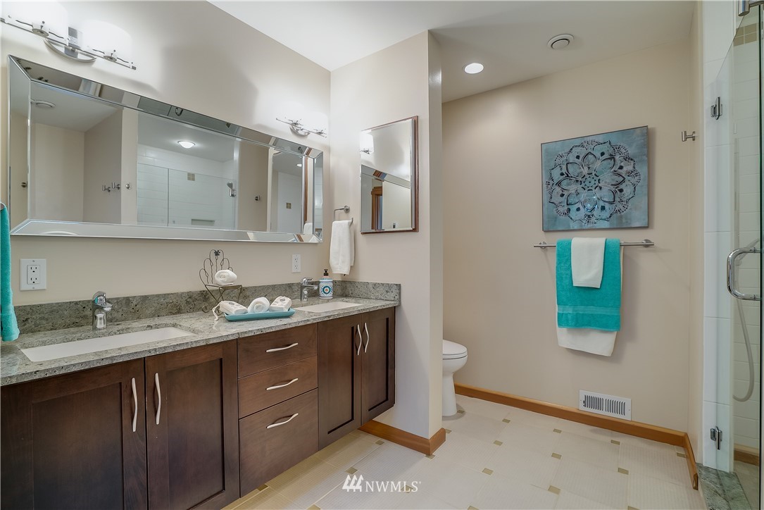 1023 West Ruffner Street Seattle, WA 98119 - Photo 17 of 25 a bathroom with a granite countertop sink mirror and vanity