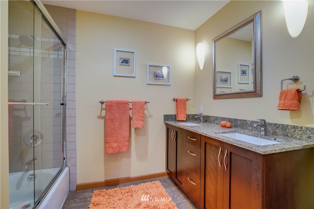 1023 West Ruffner Street Seattle, WA 98119 - Photo 20 of 25 a bathroom with a sink and a mirror