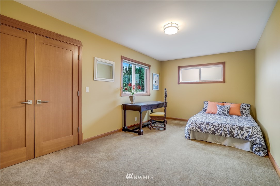 1023 West Ruffner Street Seattle, WA 98119 - Photo 22 of 25 a bedroom with a bed and a table in it