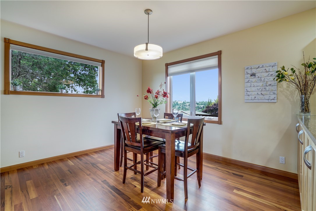 1023 West Ruffner Street Seattle, WA 98119 - Photo 6 of 25 a view of a dining room with furniture window and wooden floor
