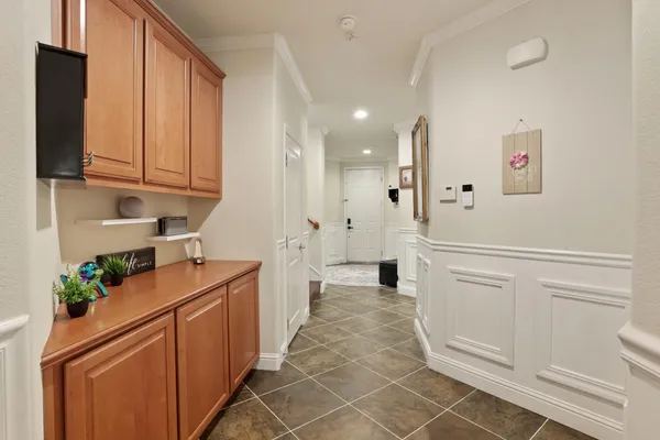 a kitchen with white cabinets and white appliances