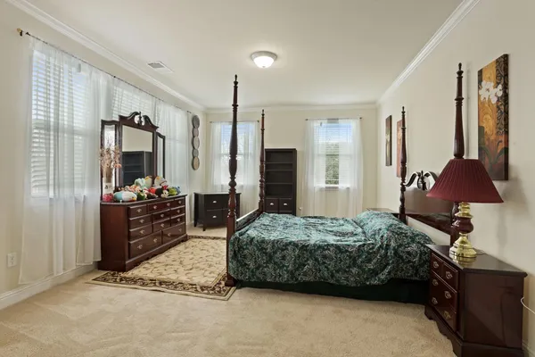 a living room with furniture a flat screen tv and kitchen view