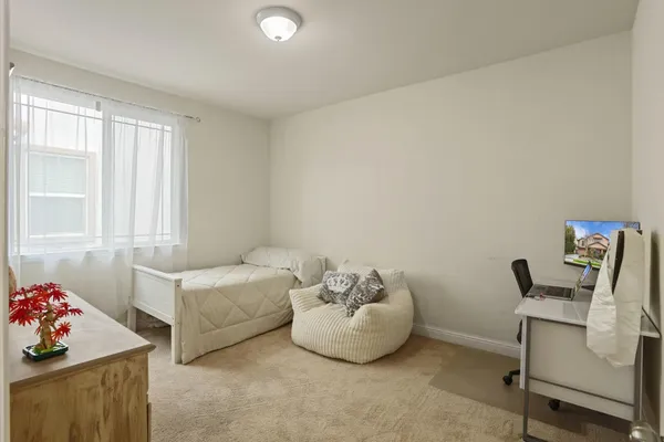 a bedroom with a bed and a mirror on dresser