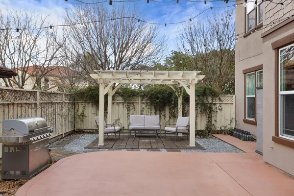 a view of a patio with a table and chairs