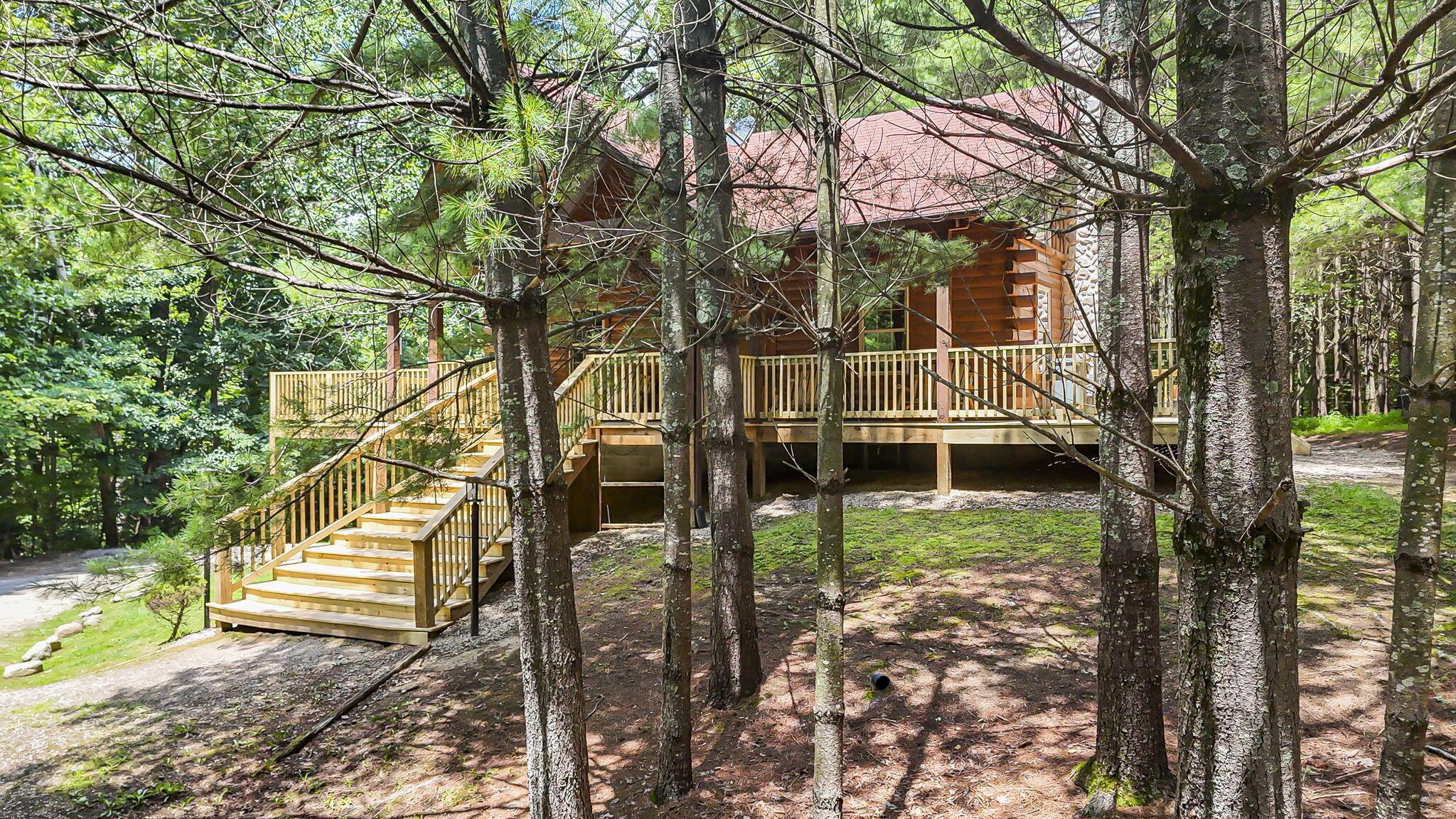 19475 Linden Road Logan, OH 43138 - Photo 78 of 94 Log home exterior featuring a full staircase, surrounded by mature trees