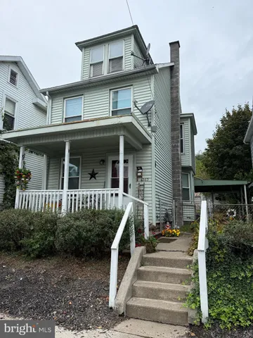 a front view of a house with stairs