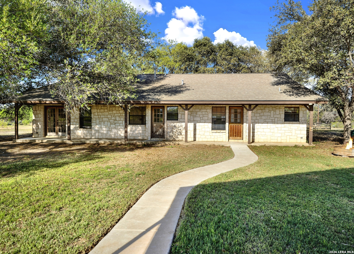 386 County Road 763 Devine, TX 78016 - Photo 20 of 49 a front view of a house with swimming pool